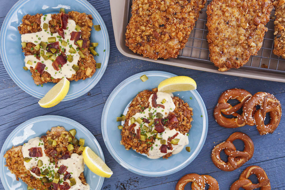 Bavarian Pretzel Schnitzel with Beer-Cheese Sauce, Bacon, Chives and Pickles