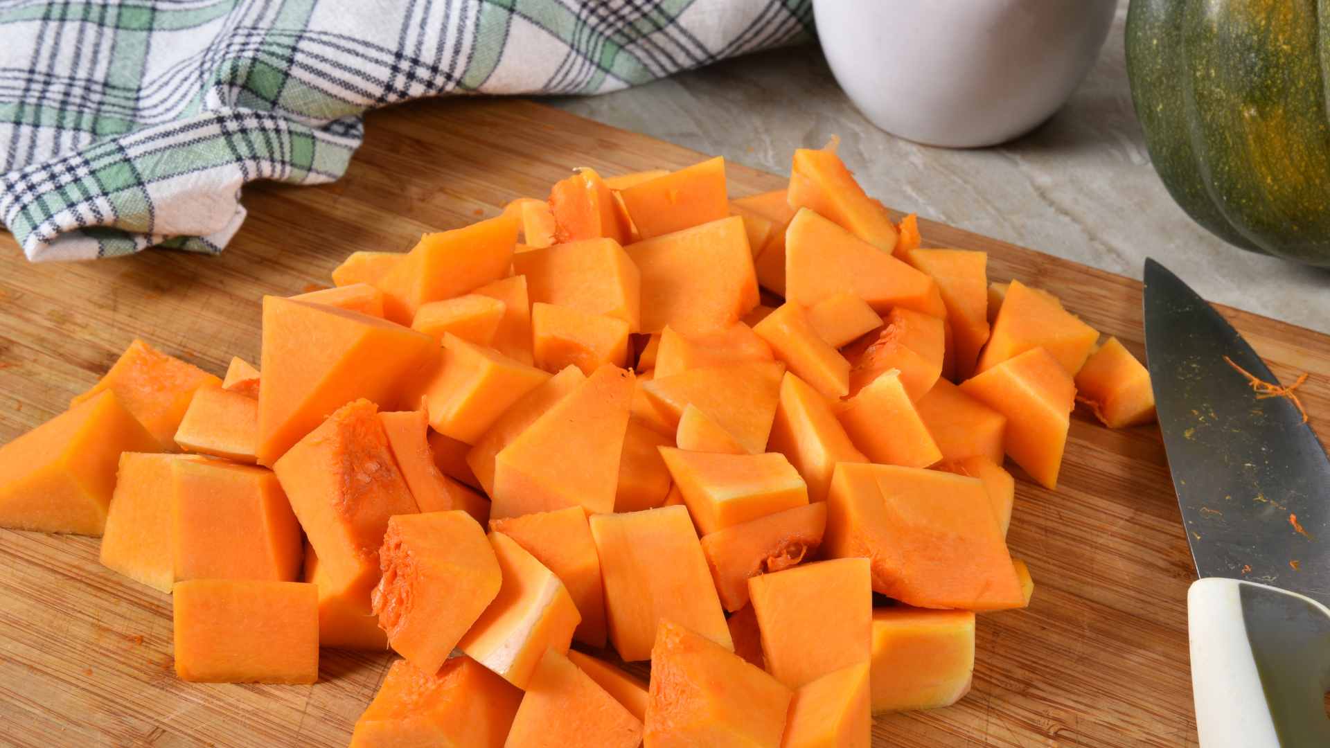 Diced Butternut Square on a Cutting Board with a Knife